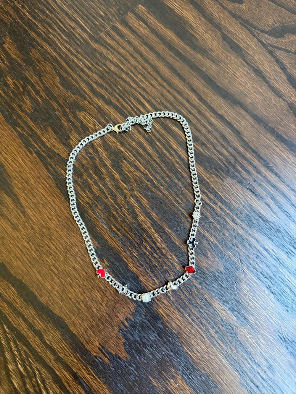 Silver-tone chain necklace featuring a collection of Vegas-inspired charms